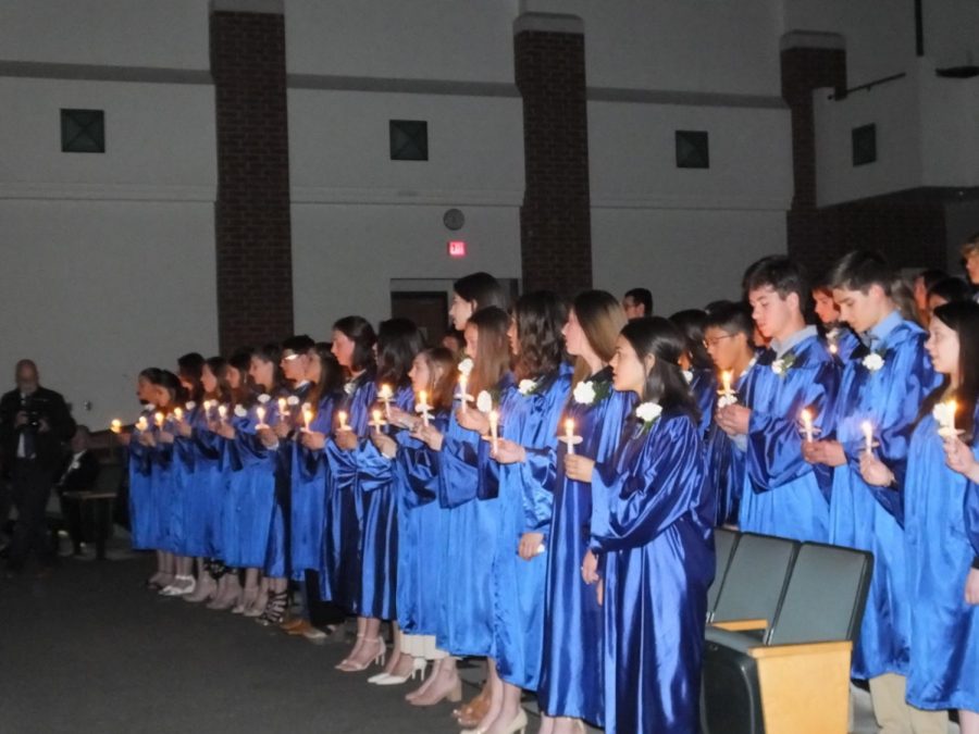 The blue robes are on, which means its National Honor Society induction. Class of 2019.