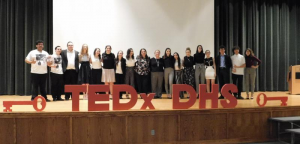 2019 presenters pose on stage with show runners Ms. True and Ms. Sousa. This was the last time that TEDx DHS was live in the auditorium.