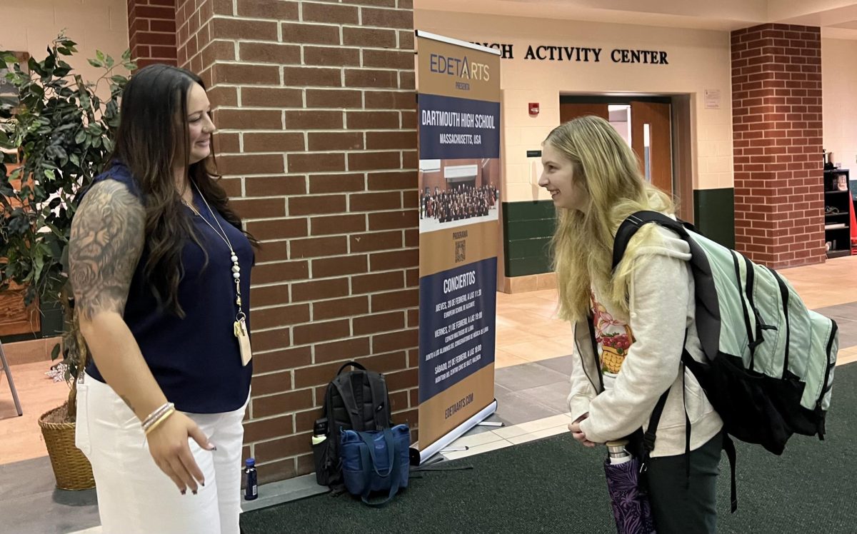 Associate Principal Stephanie Santos chats with a student before the first bell.